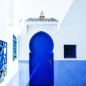 Typical blue house door in Chefchaouen, Morocco Typical blue house door in Chefchaouen, Morocco