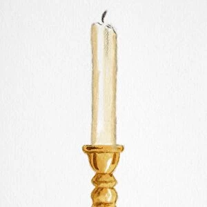Unlit wax candle in brass candlestick