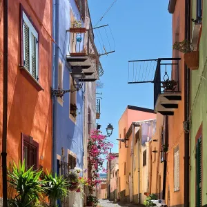 Uphill street with colourful architecture in Bosa, Sardinia, on a sunny day