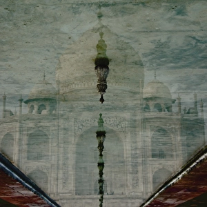 Upside-down reflection of Taj Mahal in a pool of water