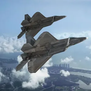 Two USAF Lockheed Martin F-22A Raptor stealth fighters flying over the coastline of Florida Two USAF Lockheed Martin F-22A Raptor stealth fighters flying over the coastline of Florida