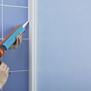 Using a sealant dispenser to seal outside edge of a shower screen