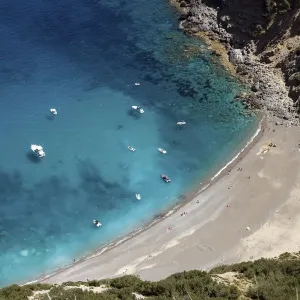 View on the beach Platja des Coll Baix, turquoise blue water, anchoring boats, peninsula View on the beach Platja des Coll Baix, turquoise blue water, anchoring boats, peninsula