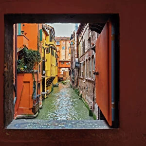 View to the canal through square window, Bologna, Emilia-Romagna, Italy