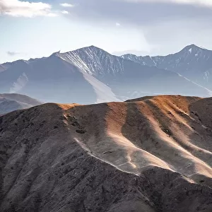 View over eroded mountainous landscape with brown hills, mountains and steppe, Chuy province, Kyrgyzstan