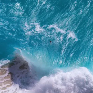 Top view of huge ocean waves at Kelingking Beach, Nusa Penida Island, Indonesia