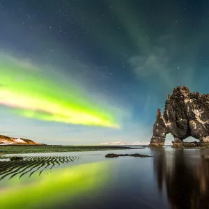 A view of Hvitserkur with aurora dancing