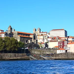View of Ribeira district from Douro river with the Church of San Francisco and Portos Cathedral in the background