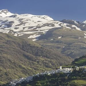 View over the town of Pampaneira towards the snow-capped Sierra Nevada Mountains, Pampaneira, Andalucia, Spain