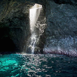Waiahuakua sea cave explored on boat tour of Na Pali Coast, Kauai, Hawaii, USA