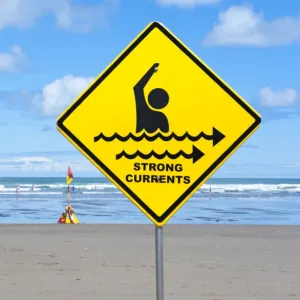 Warning sign strong currents, on a beach, Muriwai Beach, West Coast, Auckland, Auckland Region, New Zealand