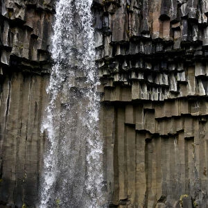 Waterfall with basalt columns in Skaftafell National Park, Iceland, Europe