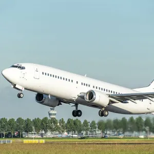 A white Boeing 737 airplane taking off A white Boeing 737 airplane taking off
