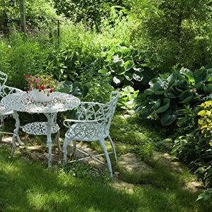 White metal garden table and chairs in a residential backyard, Quebec City, Quebec Province, Canada