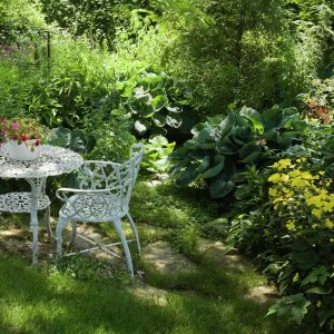 White metal garden table and chairs in a residential backyard, Quebec City, Quebec Province, Canada