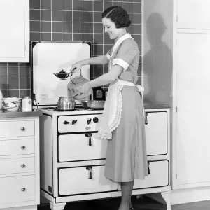 Woman In Cotton Dress & Maid Apron Standing Woman In Cotton Dress & Maid Apron Standing