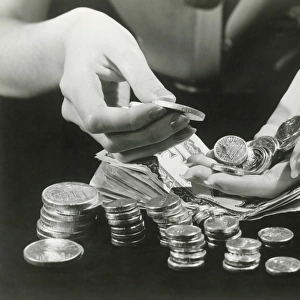 Woman counting change, close up of hands