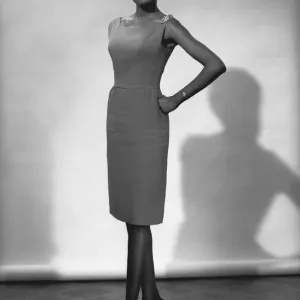 Woman in dress posing in studio, (B&W), portrait Woman in dress posing in studio, (B&W), portrait