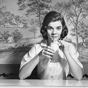 Woman drinking ice cream soda