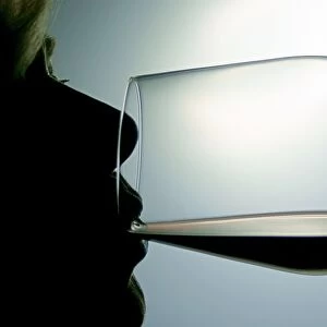 Woman drinking red wine, silhouette