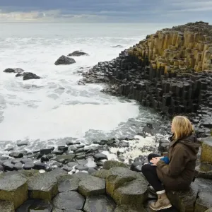 Woman in the Giants Causeway - North Ireland - United Kingdom Woman in the Giants Causeway - North Ireland - United Kingdom