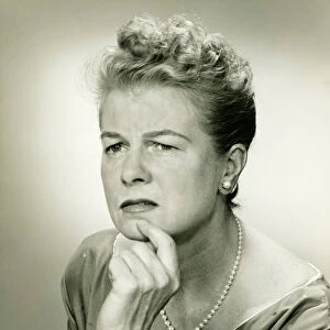 Woman with hand on chin, (B&W), portrait