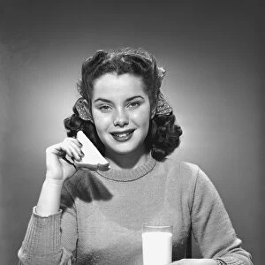 Woman having sandwich and milk, (B&W), portrait