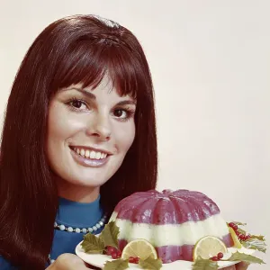 Woman holding mousse against white background, close-up, portrait