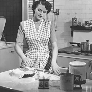 Woman in kitchen making pie (B&W)