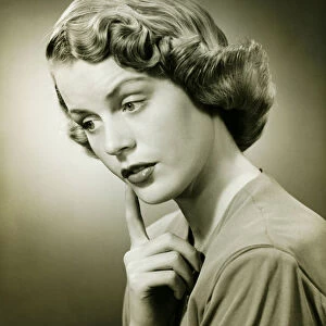 Woman looking thoughtful, posing in studio, (B&W), (Portrait)