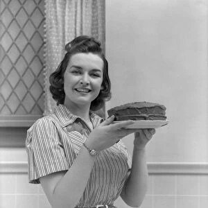 Woman (Mother, Wife) Holding Cake In Kitchen