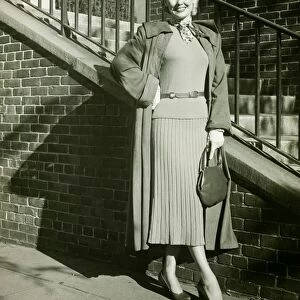 Woman posing by steps, (B&W), (Portrait)