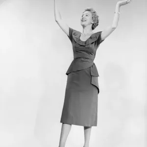 Woman raising arms, studio shot Woman raising arms, studio shot