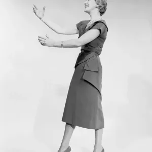 Woman raising arms, studio shot, side view Woman raising arms, studio shot, side view