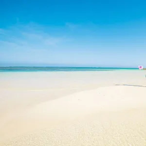 Woman with sarong in pristine waters at Turquoise Bay, Ningaloo Coast, Exmouth, Western Australia