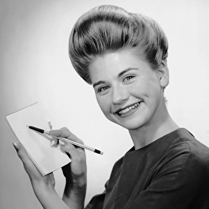 Woman smiling w / pen & pad