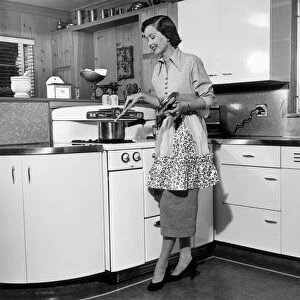 Woman stirring pot at stove