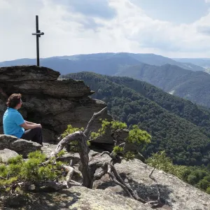 Woman at the summit cross, Hoher Stein Mountain, Muehlberg, Dunkelsteinerwald, Wachau, Mostviertel, Lower Austria, Austria, Europe Woman at the summit cross, Hoher Stein Mountain, Muehlberg, Dunkelsteinerwald, Wachau, Mostviertel, Lower Austria, Austria, Europe