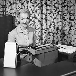Woman typing, smiling and posing