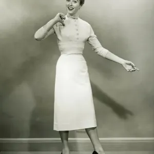 Woman in white dress pointing to herself in studio, (B&W), portrait Woman in white dress pointing to herself in studio, (B&W), portrait