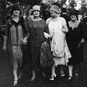 Four women walking arm in arm (B&W)