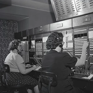 Two women wearing headsets, working on telephone switchboard. (Photo by H. Armstrong Roberts/Retrofile/Getty Images)