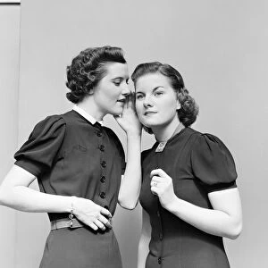 Two women whispering. (Photo by H. Armstrong Roberts / Retrofile / Getty Images)