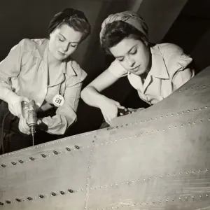 Women working on WW II aircraft assembly Women working on WW II aircraft assembly