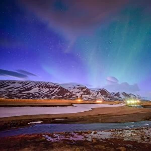 Wooden house on the background of the aurora in winter, Iceland