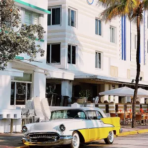 Yellow vintage car on Ocean Drive road, South Beach, Miami, USA