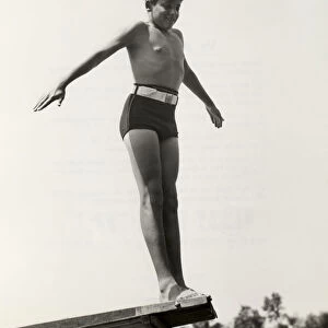 Young boy at end of diving board