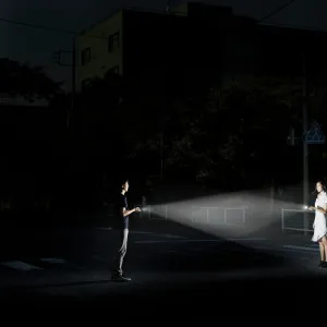 young couple with flashlights