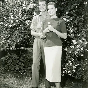 Young couple standing in garden