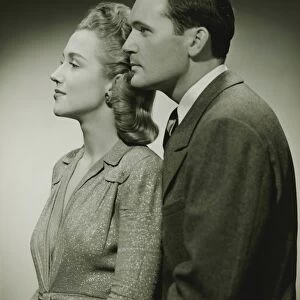 Young couple in studio, (B&W), close-up